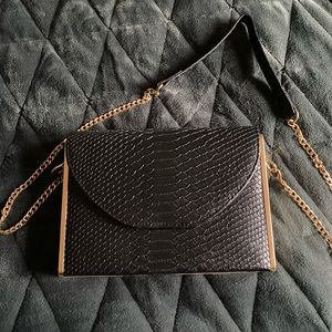 Madison west black crocodile skin purse with gold accents